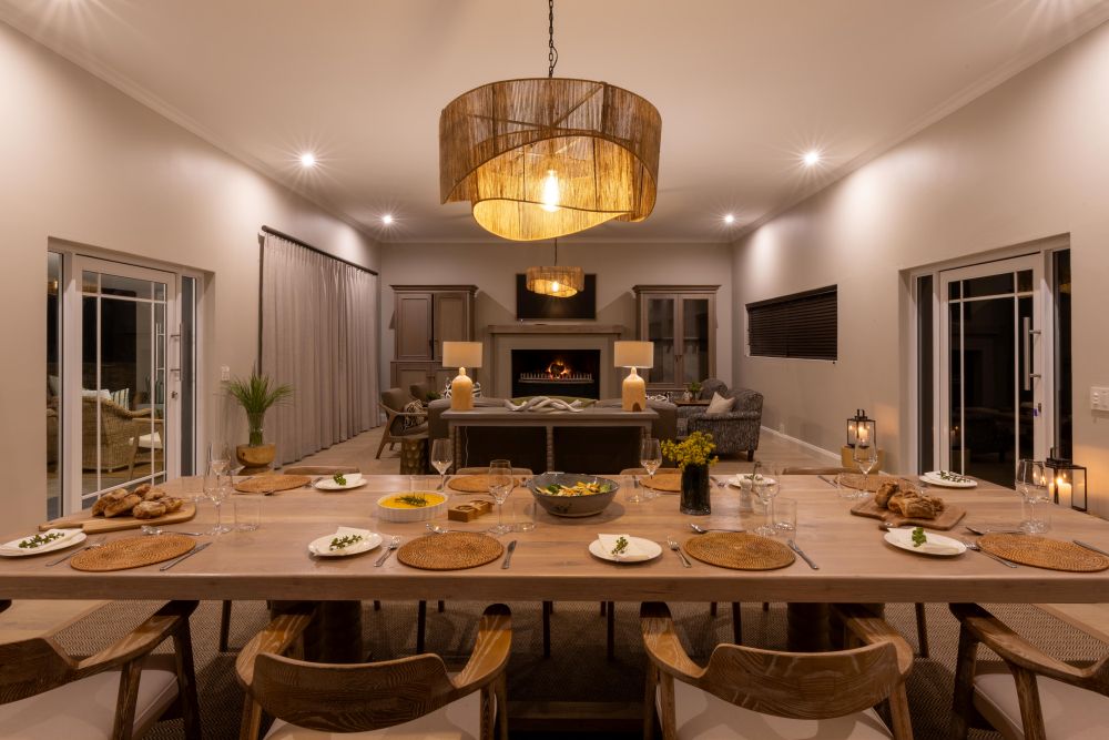Elegant dining table set beneath chandelier in modern living room